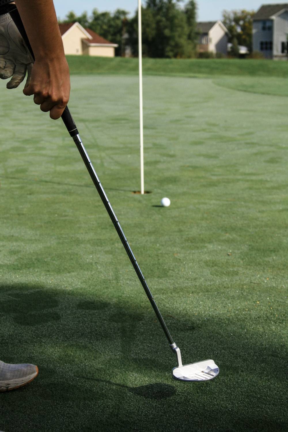 Golfer pushing a putt to the right of the hole